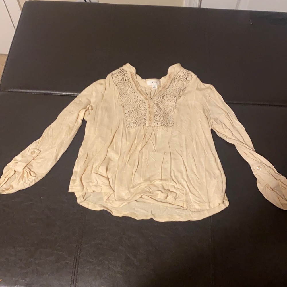 Cream top with crochet detail on front